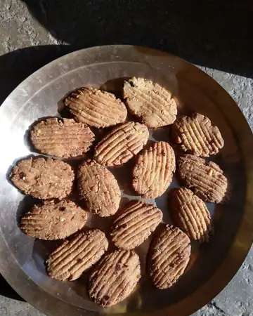 A steel plate of ridged, brown khurmi sweet biscuits