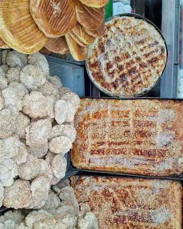 Round and flat Kashmiri breads and bakery biscuits piled in trays