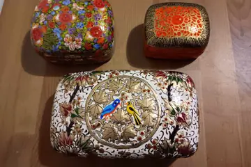 Three painted papier-mâché trinket boxes with flower and bird designs