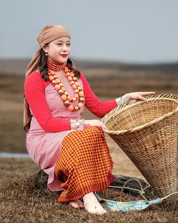 A woman in Khasi dress with a cane basket