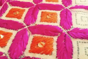 Pink and orange phulkari stitches on cream cloth in Rajpura