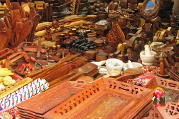 A stall in Haridwar piled with carved wooden trays, spoons, boxes and mortars