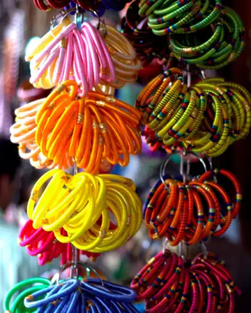 Hoops of pink, orange, yellow, blue and green bangles hanging in a shop