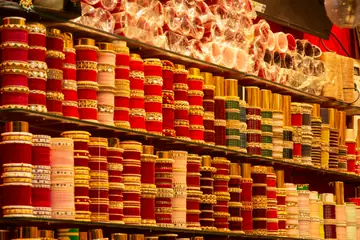 Shelves of red and gold bangles in a bangle shop