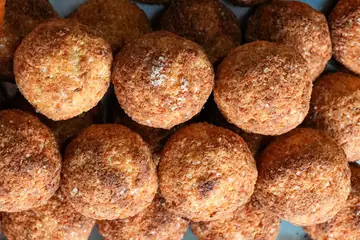 A tray of golden coconut balls in a bakery's display in Ooty, Tamil Nadu