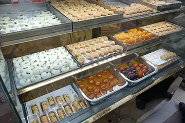 Trays of milk sweets, pedas and gulab jamun in a sweet-shop counter
